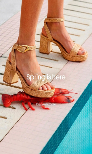 “Detail of feet in beige raffia heeled sandals stepping on a red lobster next to a blue pool, with ‘Spring is here’ and ‘Discover more’ text.”