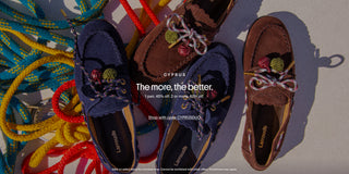 Hero banner featuring three pairs of Larroudé Cyprus suede boat shoes in navy and brown suede with multicolored rope laces, arranged on bright nautical ropes. Text promotes 40% off one pair or 60% off two or more pairs with code CYPRUSDUO.