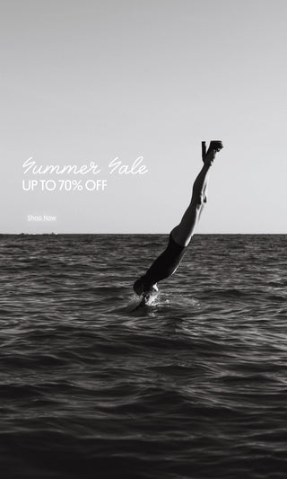 Black-and-white editorial image of a woman diving into the ocean for the Larroudé Summer Sale campaign.