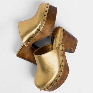 Larroudé metallic gold leather platform clogs with wooden heels and studded detailing, displayed on a white background.