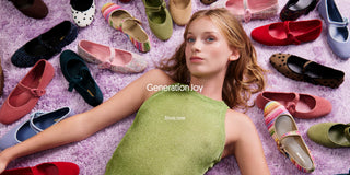 A young woman lying on a lavender rug, surrounded by colorful shoes, with the text “Generation Joy” and “Shop now” overlaid on the image