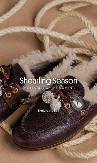 Brown leather Larroudé shearling-lined loafers with decorative laces and textured details.